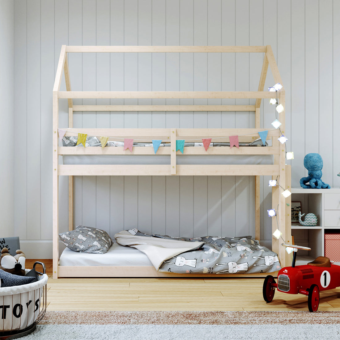 Brook Timber House Design Kids Twin Bunk Bed - Natural, featuring a cubby house-inspired frame with a high-pitched roof and built-in ladder, displayed in a cozy room with a blue stuffed animal.