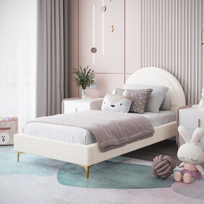 Camryn Kids Single Bouclé Bed Frame in Cream White, featuring a rounded headboard, is adorned with light gray sheets and a muted mauve quilt, complemented by decorative pillows for a cozy children's bedroom setting.