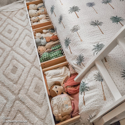 Cornelia Storage Triple Bunk Bed - White Solid Wood, featuring full-length guard rails, a solid wood ladder, and spacious under-bed drawers filled with stuffed animals for added storage and child-friendly design.
