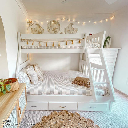 Cornelia Storage Triple Bunk Bed - White Solid Wood: A sleek triple bunk bed with guard rails, a solid ladder, and three under-bed drawers, providing practical storage in a compact, stylish design.