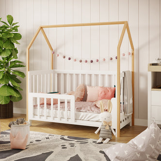 Damaris & Giro Baby Cot & Toddler Bed Kit Set in White features a house-frame design with a string of felt ball lights, pastel bedding, and a plush bunny, nestled in a cozy nursery corner.