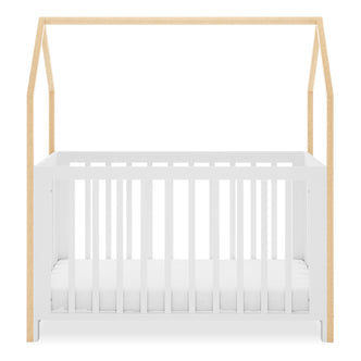 Damaris Solid Pine Baby Cot Bed - White/Natural features a house-shaped canopy frame with white vertical slats and light wood posts, blending style and functionality for a modern nursery.