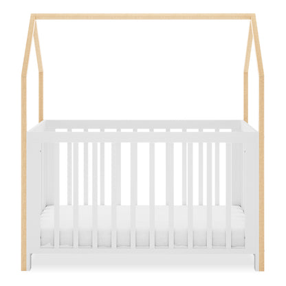 Damaris Solid Pine Baby Cot Bed - White/Natural features a house-shaped canopy frame with white vertical slats and light wood posts, blending style and functionality for a modern nursery.