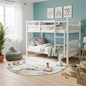 Dante 2-in-1 Solid Pine Timber Bunk Bed in White against a teal wall, adorned with pastel bedding and prints above, beside a window, rug, and toys, enhancing a cheerful children’s bedroom.