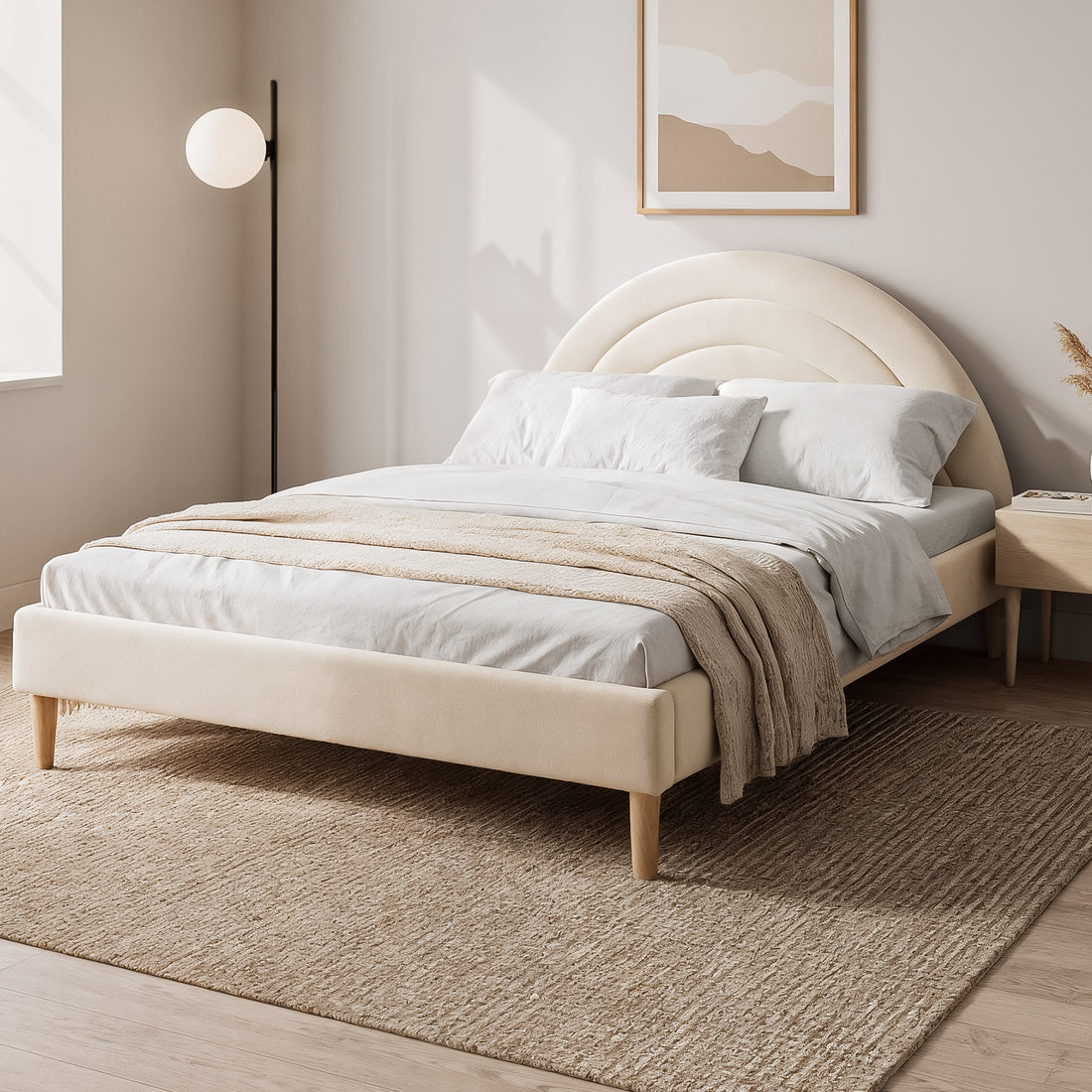 Estilla Kids Velvet Rainbow Double Bed in Beige features a scalloped headboard, white linens, and a beige throw on a woven rug, with a nightstand and floor lamp completing the serene setup.