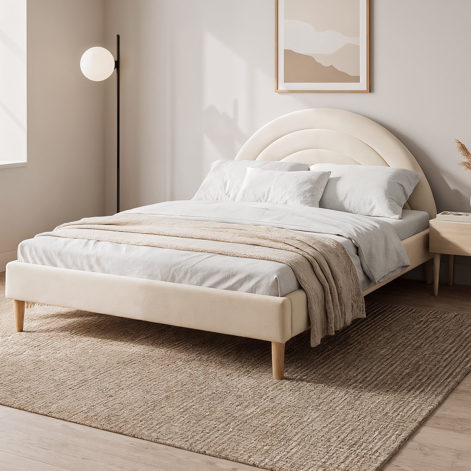 Estilla Kids Velvet Rainbow Double Bed in Beige features a scalloped headboard, white linens, and a beige throw on a woven rug, with a nightstand and floor lamp completing the serene setup.