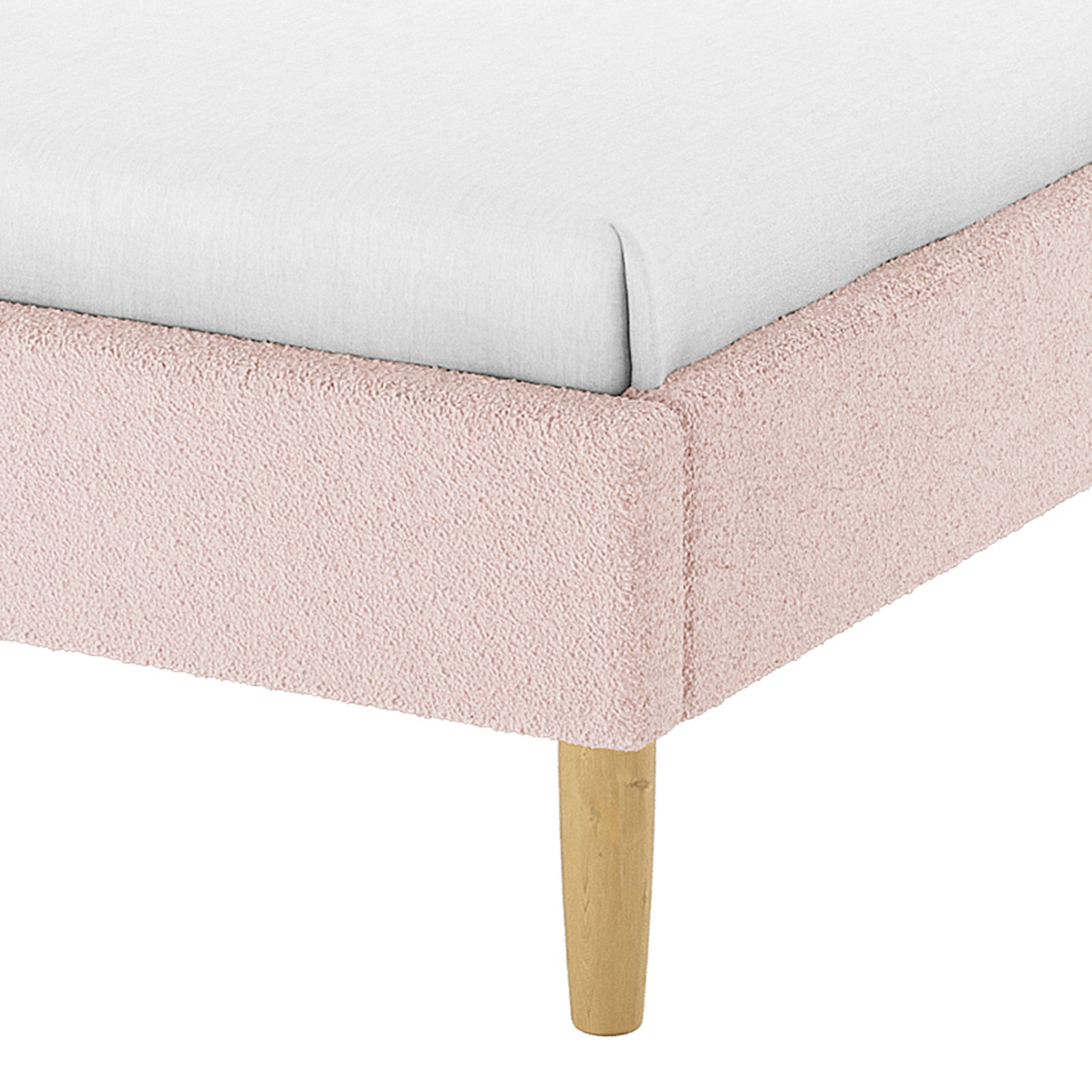 Close-up of Estilla Double Rainbow Boucle Bed Frame, showcasing light pink boucle upholstery, tapered wooden leg, and white fitted sheet, highlighting its playful and cosy design for children's bedrooms.