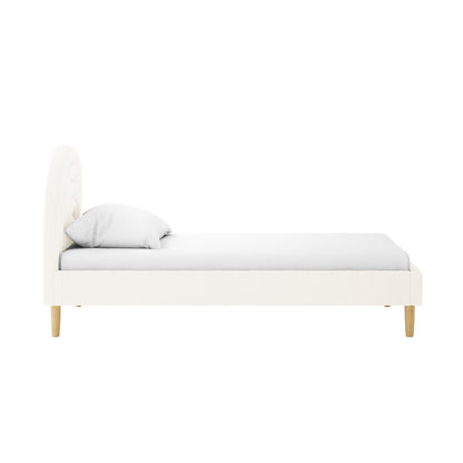 Estilla Single Rainbow Boucle Bed Frame in Cream White, featuring a curved padded headboard, white upholstery, single pillow, mattress, and four light-wood tapered legs. Perfect for kids or guest rooms.