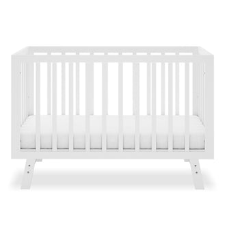 Eudora Classic Solid Pine Adjustable Nursery Cot – White, featuring a modern design with slatted sides and thin mattress, crafted for safety and longevity in a baby's nursery.