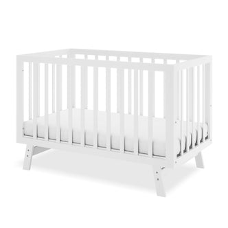 Eudora Classic Solid Pine Adjustable Nursery Cot – White: A modern white wooden crib with slatted sides and included mattress, showcasing clean lines and sturdy pine construction for a safe, timeless nursery.