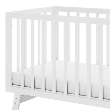 Eudora Classic Solid Pine Adjustable Nursery Cot – White, features a simple white wooden frame with vertical slats and a thin mattress, showcasing its timeless design and sturdy construction.