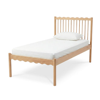 Light wood single bed frame with slatted headboard and wavy top edge on white background