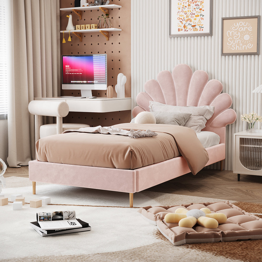Fayette Kids Single Velvet Fabric Bed Frame in Soft Pink features a scallop-shell headboard, blush-pink upholstery, and light wooden legs, set in a pastel-themed bedroom with cozy, neutral decor.