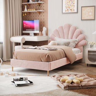 Fayette Kids Single Velvet Fabric Bed Frame in Soft Pink features a scallop-shell headboard, blush-pink upholstery, and light wooden legs, set in a pastel-themed bedroom with cozy, neutral decor.