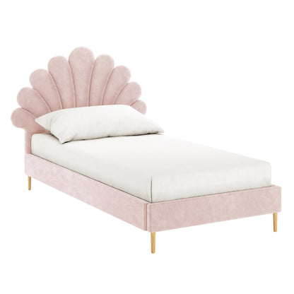 The Fayette Kids Single Velvet Fabric Bed Frame in Soft Pink features a scalloped, shell-like headboard and slender wooden legs, upholstered in blush-pink velvet, complete with a white fitted sheet and pillow.