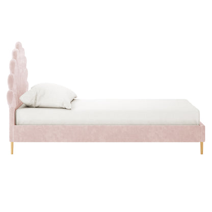 Fayette Kids Single Velvet Fabric Bed Frame in Soft Pink, featuring a scalloped, petal-like headboard, blush-pink upholstery, and slender light-wood legs, dressed with a white fitted sheet and pillow.