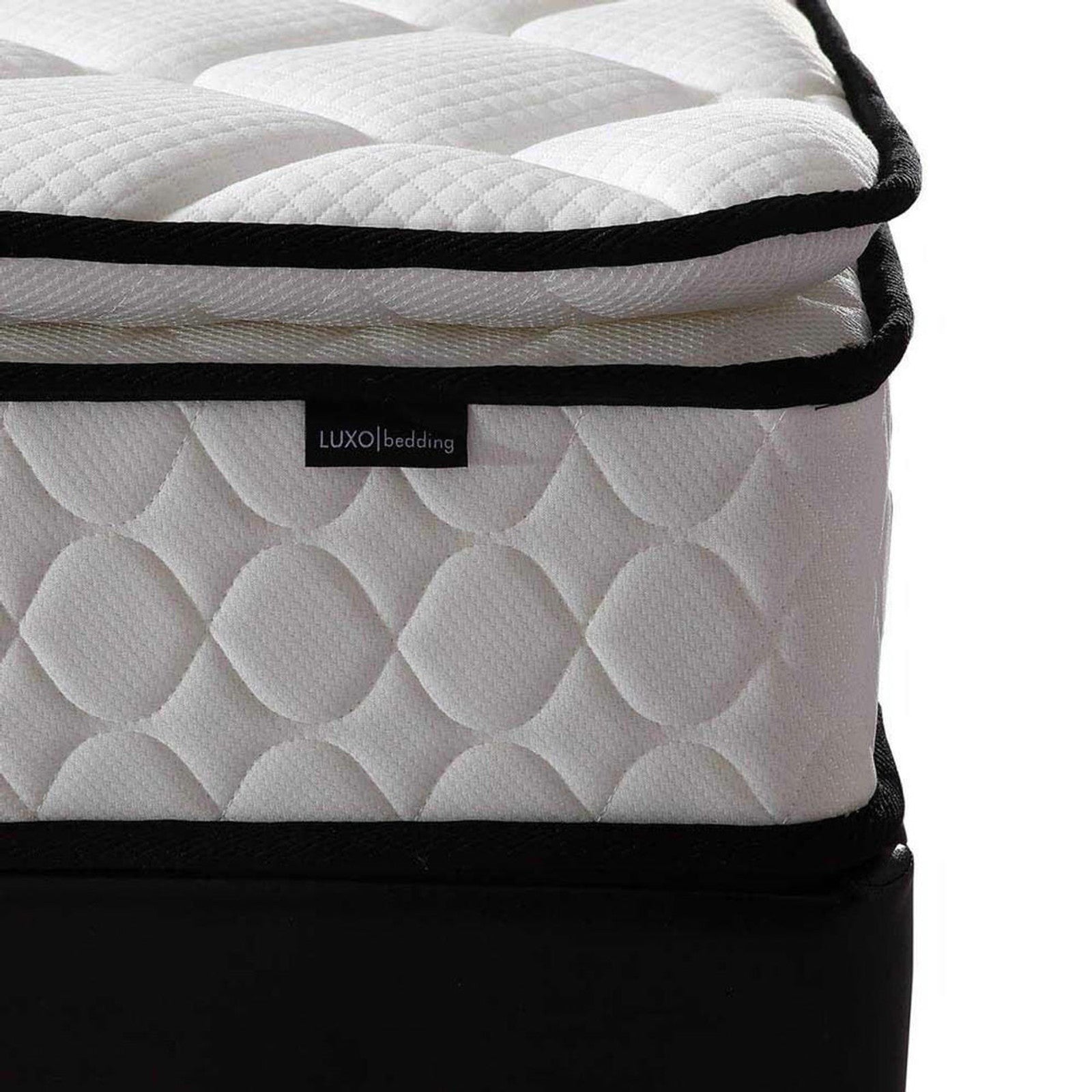 Close-up of Venus Mattress from Aristos & Venus Bunk Bed & Mattress Package, featuring a quilted white cover with raised pattern, black piping, and LUXO bedding tag, resting on a black foundation.