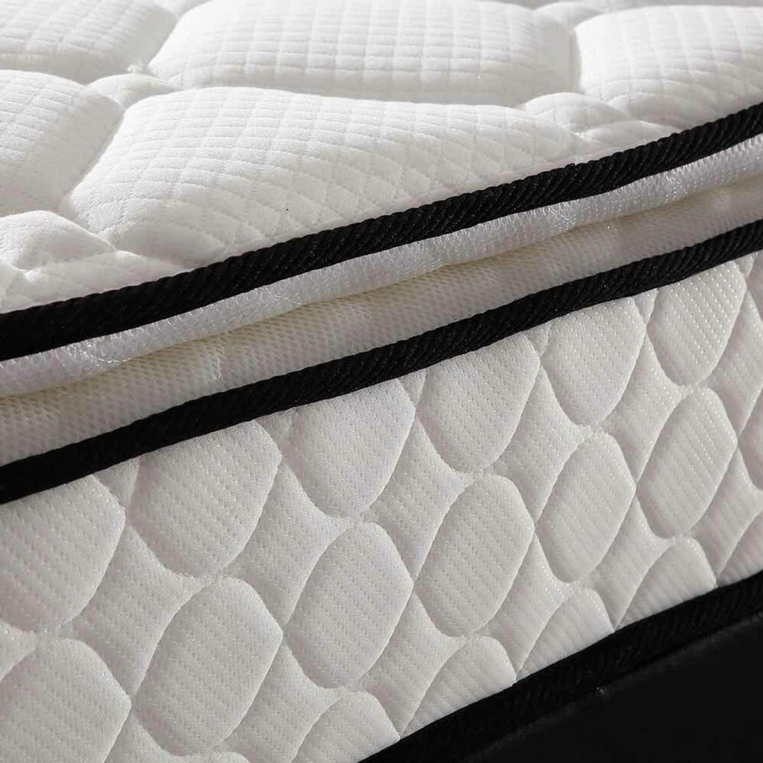 Close-up of the Venus Mattress from the Aristos & Venus Bunk Bed & Mattress Package, featuring a quilted white fabric cover with raised oval patterns and black binding trim.