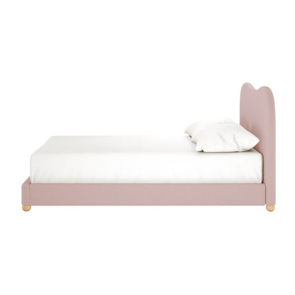 Ginnie Double Curved Bouclé Cloud Bed Frame in Pink, showcasing its side-view with a plush, curved headboard upholstered in soft bouclé, topped with a white mattress and pillow against a white background.
