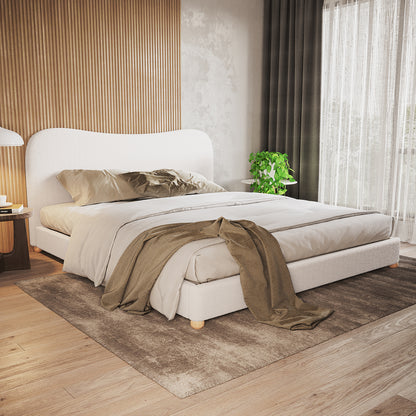 Ginnie Bouclé Curved King Bed Frame - Cream White in a minimalist bedroom with ribbed wood accent wall, neutral bedding, wooden bedside table, and soft natural light from floor-to-ceiling windows.