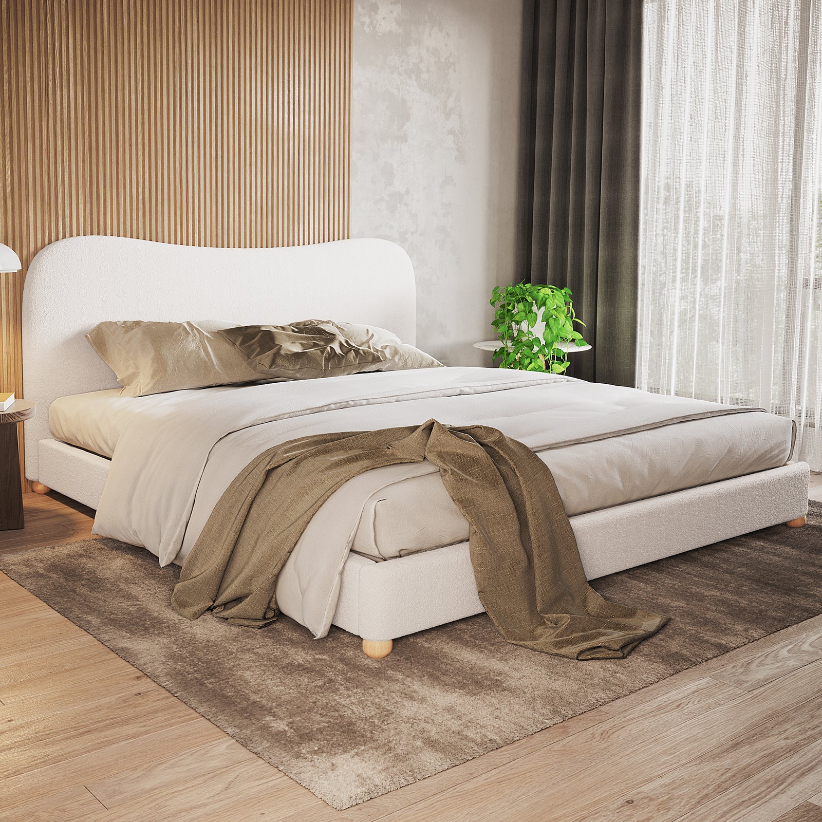 Ginnie Boucle Bed & Oriona Mattress - Super King, featuring a plush curved headboard and sleek design, complemented by a neatly arranged pillow and a nearby potted plant enhancing the bedroom setting.