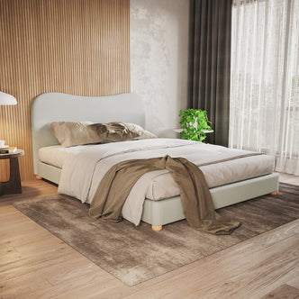 Ginnie Linen Curved Queen Bed Frame - Grey: Showcased in a serene bedroom corner, featuring a plush curved headboard, premium linen upholstery, and solid timber legs on a natural wood floor.