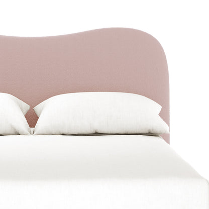 Ginnie Queen Curved Bouclé Cloud Bed Frame in Pink features a softly rounded, upholstered headboard in blush pink, complemented by two white pillows and a white bedspread for modern elegance.