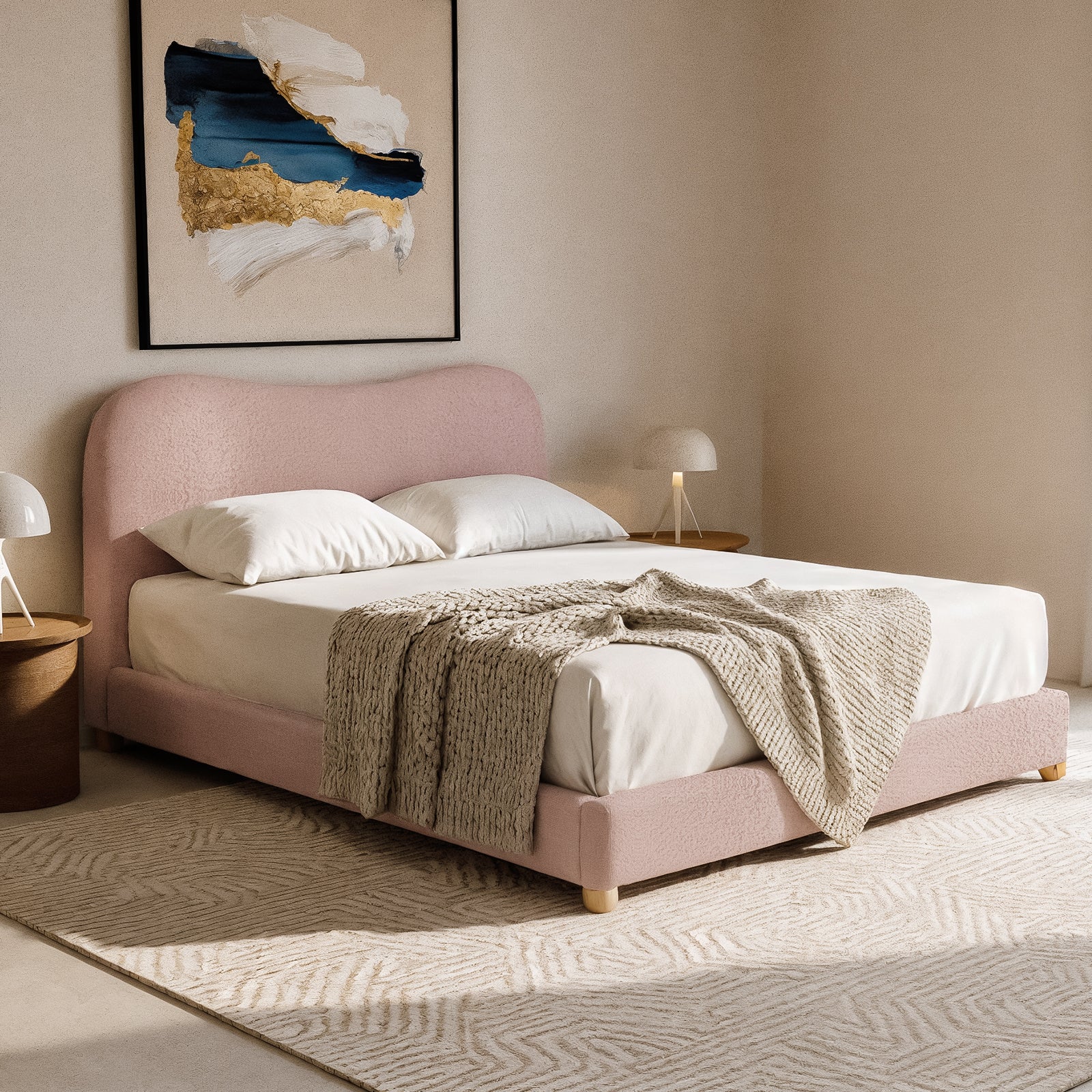 Ginnie Queen Curved Boucle Cloud Bed Frame in Pink with a plush curved headboard, upholstered in soft bouclé fabric, set in a minimalist bedroom with modern nightstands and abstract painting.