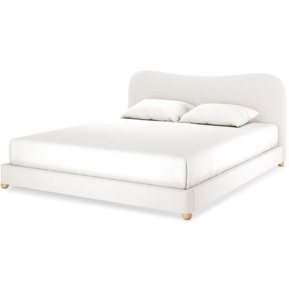 Ginnie Curved Bouclé Bed Frame - Cream White Super King features a low-profile design with an off-white upholstered frame, rounded wooden feet, and a 13cm curved headboard, complemented by a plain white mattress and pillows.