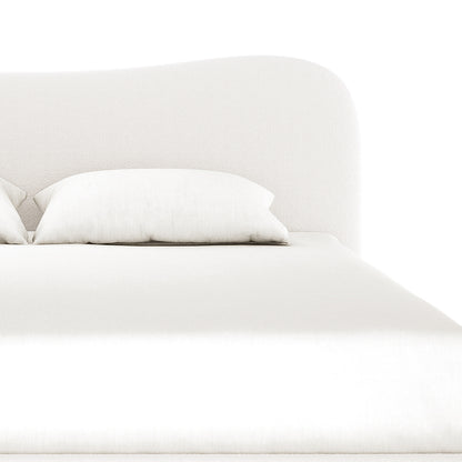 Ginnie Curved Bouclé Bed Frame - Cream White features a softly curved headboard with a plush bouclé texture, a neatly made mattress, and two white pillows, creating a serene bedroom setting.