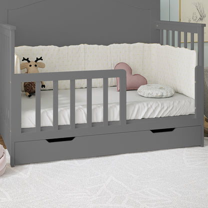 Giro Solid Pine Toddler Bed Rail Kit in Grey shown as a daybed/crib with low front rail, full side rails, pull-out drawer, white sheet, bumper, plush deer, heart cushion, and bolster pillow.