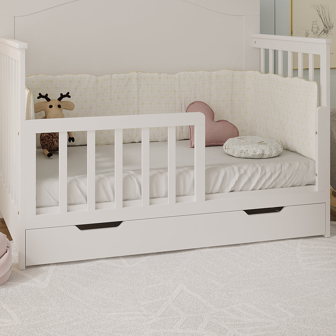 Giro Solid Pine Toddler Bed Rail Kit in White, featuring slatted side rails and a low front guard, with plush deer, pink heart cushion, and patterned pillow on the mattress.