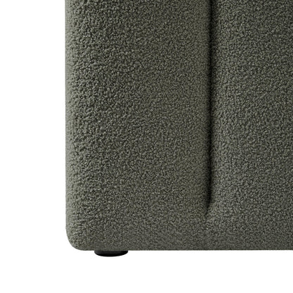 Close-up of the Aquila King Extra Wide Bouclé Headboard in Green, showcasing its tightly-looped bouclé fabric and a low-profile plastic foot, emphasizing its elegant texture and sturdy design.