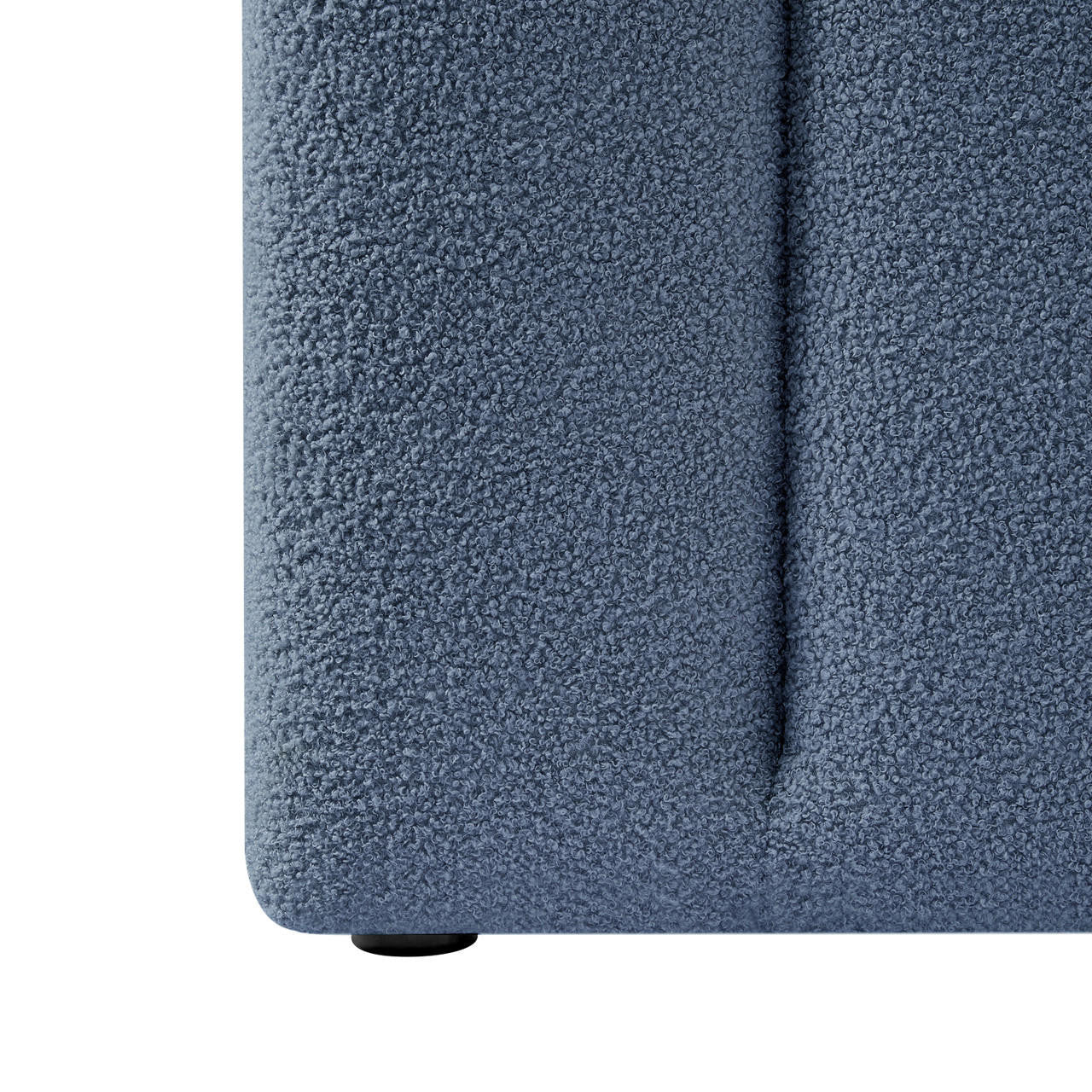 Close-up of Aquila Extra Wide King Bouclé Headboard in Midnight Blue, showcasing the textured bouclé fabric, vertical seam, and protective round glide at the base, highlighting luxurious design and craftsmanship.