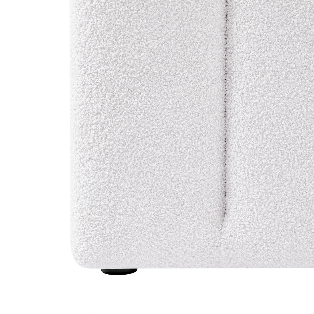 Close-up of the Aquila & Fabia Bed Package - Cream White Queen, showcasing the white bouclé fabric upholstery with a visible vertical seam and one small, round black foot at the bottom.