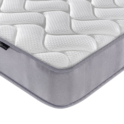 Close-up of the Harel & Vesta Slide Bunk Bed & Vesta Mattress Set in Natural, highlighting the quilted Vesta mattress corner with padded white surface and grey side panel for optimal comfort.