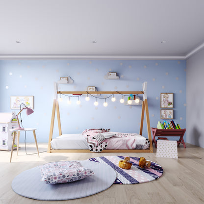 Helena Kids Single Solid Pine Teepee Bed Frame in Natural, featuring a wooden house design draped with string lights, set against polka dot walls, surrounded by playful children's decor and accessories.
