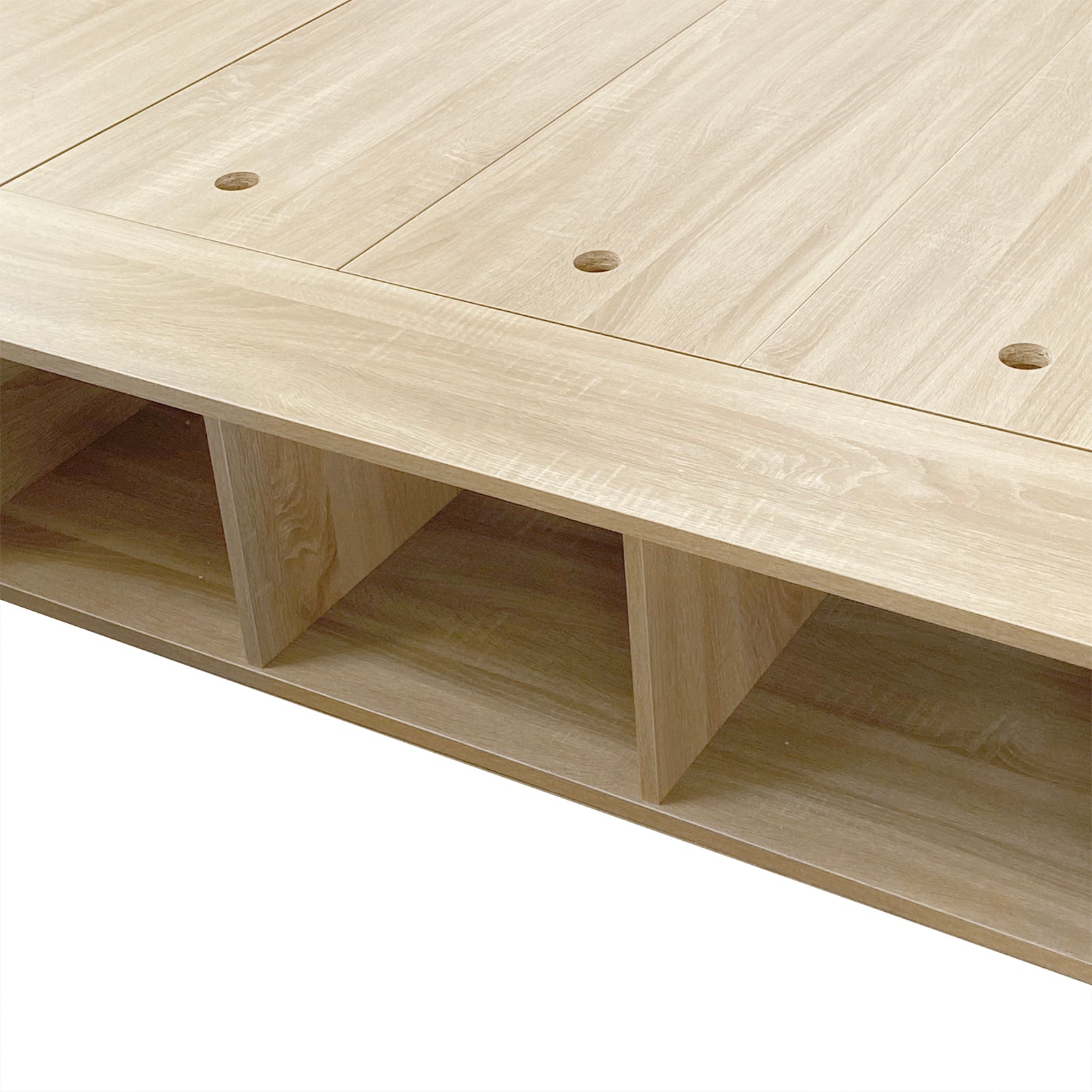 Herais Double Platform Bed Base with Storage in Oak, featuring a light-oak wooden platform with top slatted panels and three open cubbyholes underneath for versatile storage solutions.