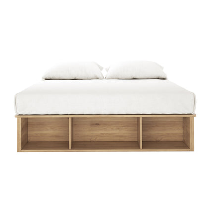 Herais Queen Platform Bed Base with Storage in Oak features a light-oak finish, low wooden frame, and three open cubby compartments at the foot, topped with a white mattress and pillows.