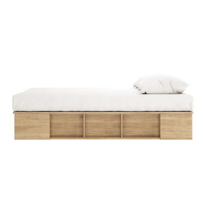 Herais Queen Platform Bed Base with Storage in Oak features a minimalist wooden frame with built-in side storage cubbies, topped by a white mattress and pillow.