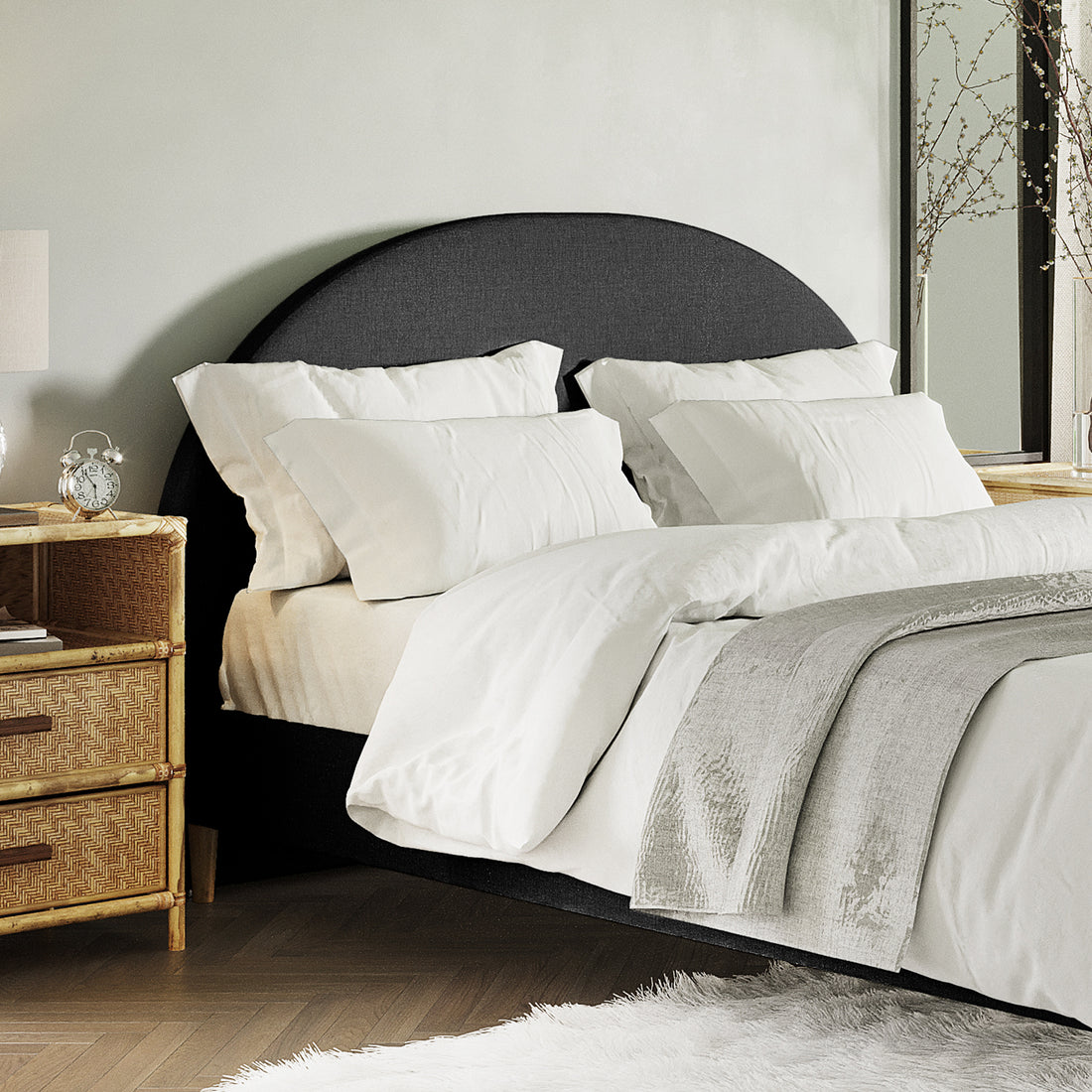 Florus Queen Arched Bouclé Fabric Headboard in Black features prominently with its curved silhouette and plush upholstery, set against a backdrop of crisp white bedding and a stylishly arranged bedroom corner.