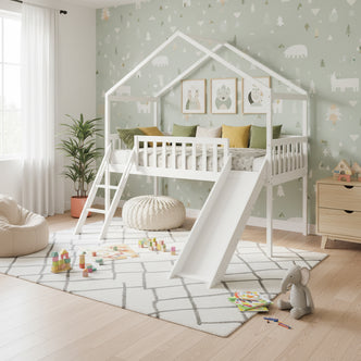 Inala Kids House Solid Pine Bed with Slide in White features a loft-style house frame, safety rails, short ladder, and slide, set in a playful children's room with cozy decor and toys.