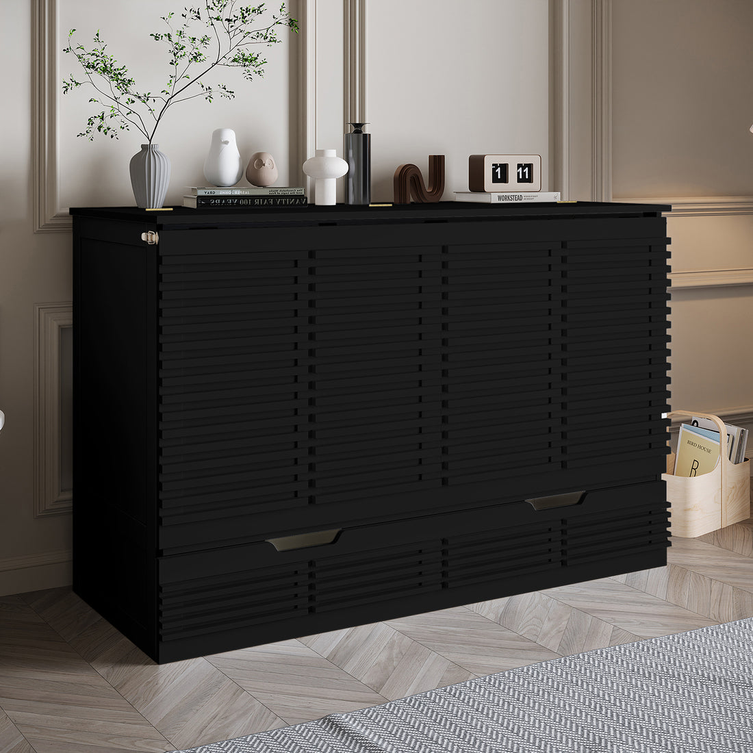 Jaxen Smart Queen Foldout Murphy Bed with Storage, featuring a sleek black cabinet with drawers, adorned with decorative objects and a vase with a tree.