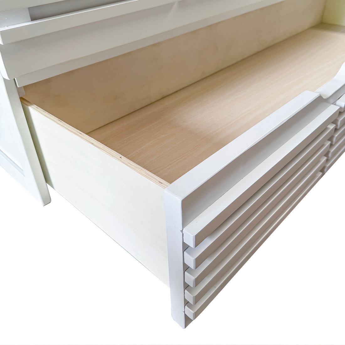 Close-up of the Jaxen Smart Queen Murphy Bed's empty drawer, showcasing its white slatted front and natural wood interior, highlighting the bed's sleek design and space-saving functionality.