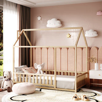 Jesse Kids Solid Pine Single House Bed - Natural, featuring a house-shaped frame with guard rails, plush elephant toy, animal-face slippers, and cloud wall lights, styled in a pastel-themed kids' room.