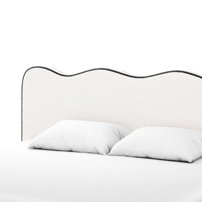 Kaylie King Boucle Fabric Bed Frame in White & Black features a wave-shaped upholstered headboard with dark piping, complemented by two white pillows and a bedcover, showcasing a minimalist and modern bedding setup.
