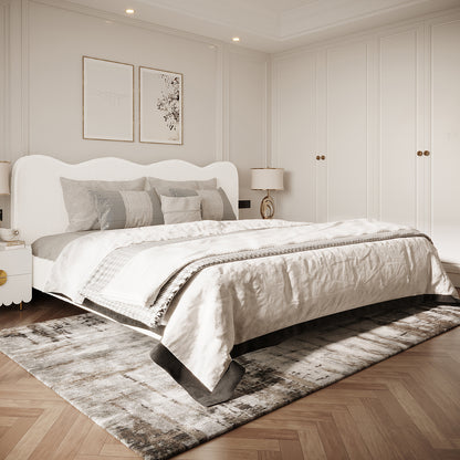 Kaylie King Boucle Fabric Bed Frame in Cream White, featuring a curved headboard and plush design, elegantly anchors a minimalist bedroom with beige-gray linens and sculptural lamps on matching nightstands.