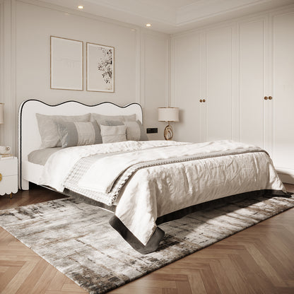 Kaylie Queen Boucle Fabric Bed Frame in White & Black features a scalloped upholstered headboard, softly lit in a modern-classic bedroom with layered bedding and coordinating pillows, enhancing its elegant appeal.