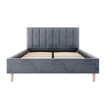 Kelly Double Velvet Bed Frame – Grey features a sleek rectangular headboard with vertical channel tufting, supported by mid-century tapered wood legs, showcasing a luxury design and solid construction.