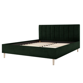 Close-up of the Kelly Queen Velvet Bed Frame in Dark Forest Green, showcasing its channel-tufted green headboard and sturdy design with a visible black border, highlighting its elegant and robust features.